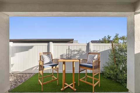 A patio with a table and two chairs.