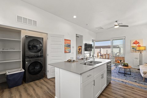 A modern kitchen with white cabinets and a large island.