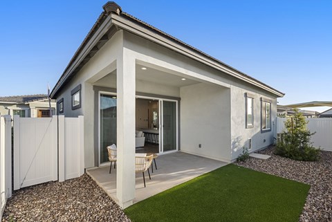 A modern house with a white exterior and a small garden area.