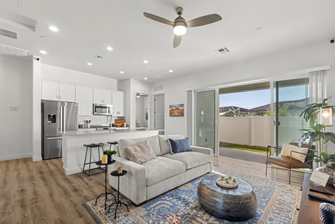 A modern living room with a white sofa and a glass table.