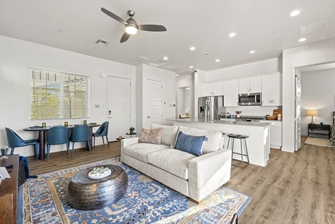 A modern living room with a white couch and a coffee table.