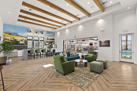 A living room with a green couch and a wooden floor.