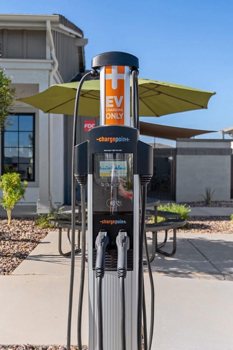 A charging station for electric vehicles is located on a sidewalk.
