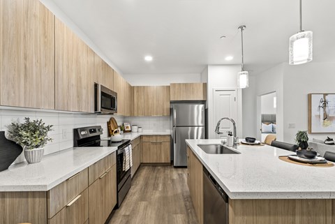 A modern kitchen with wooden cabinets and stainless steel appliances.