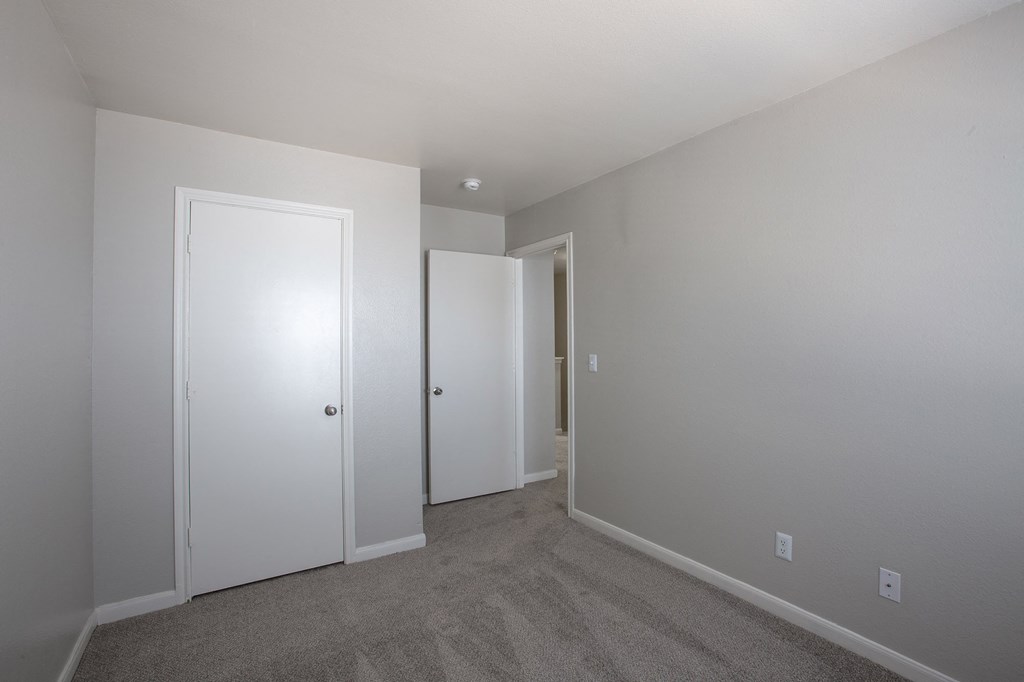 Bedroom with Carpet and Closet at The Bluffs at Tierra Contenta Apartments in Santa Fe New Mexico