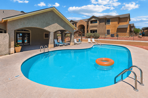 A swimming pool with a blue water and orange ring in the middle.