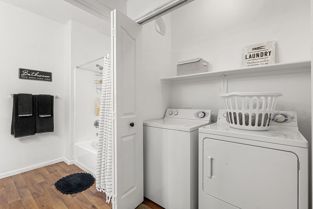A small laundry room with a washer and dryer.