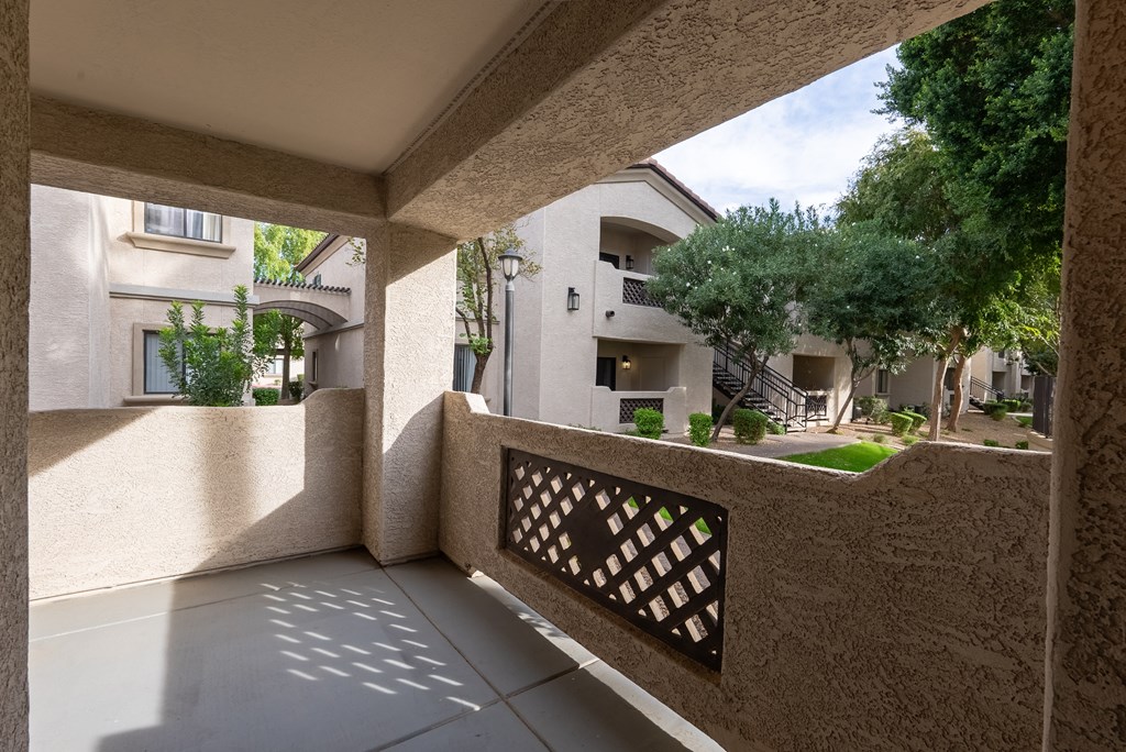 A balcony with a lattice design in the middle of it.