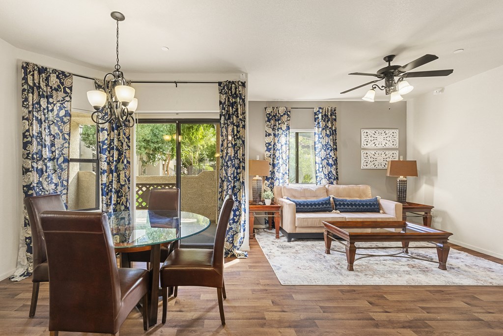 A living room with a glass table and chairs.