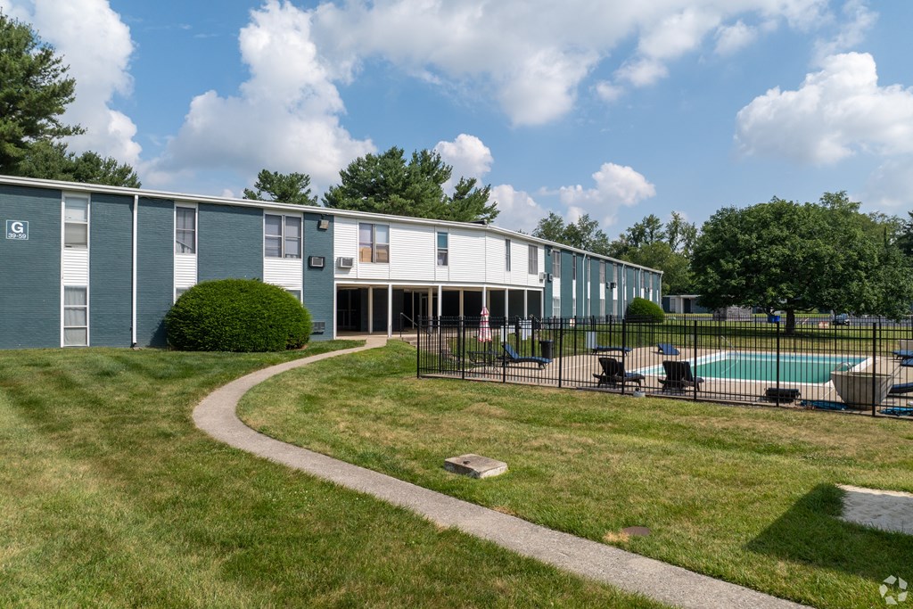 A building with a pool in front of it.