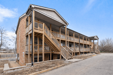 A large multi-story building with a balcony and stairs.