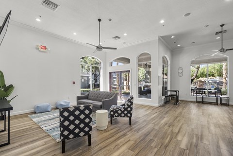 A living room with a grey couch and a black and white chair.