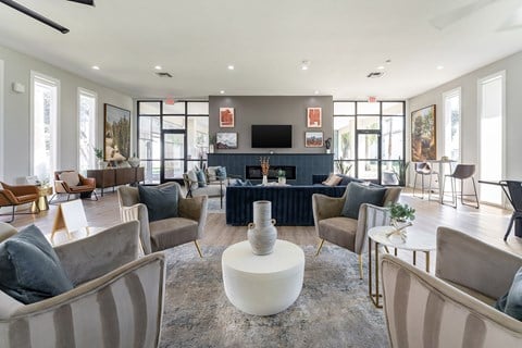 A living room with a grey sofa and a white coffee table.