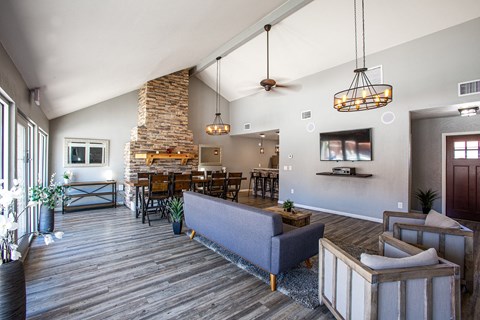 the living room of a house with a couch and a table and chairs