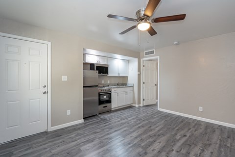 A kitchen with a fan and a stove top oven.