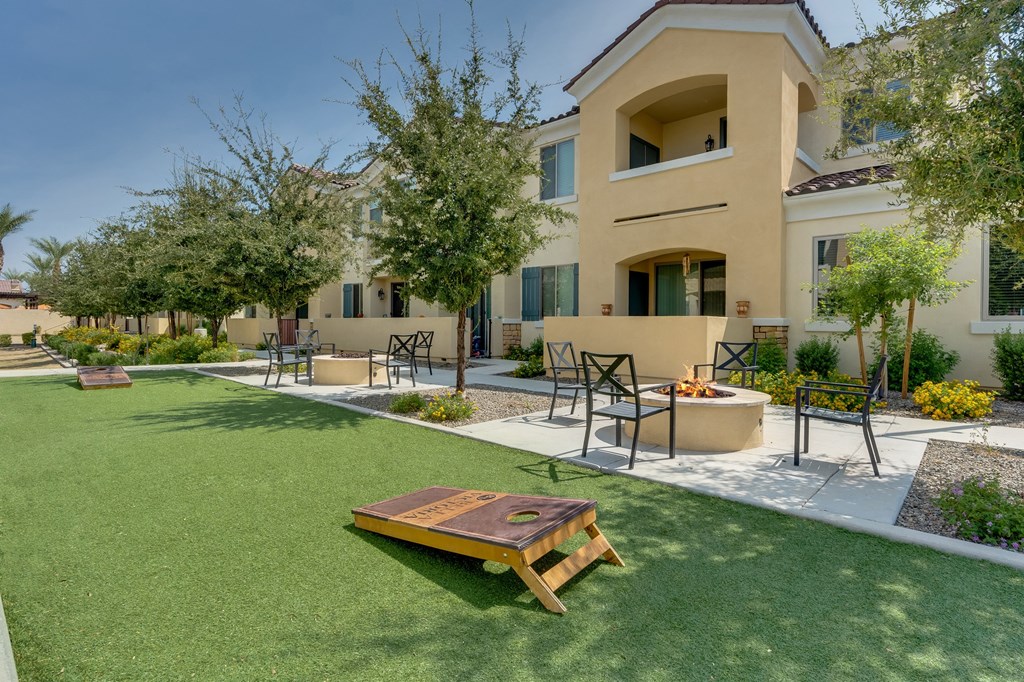 Cornhole and firepit area at Bella Victoria Apartments in Mesa Arizona January 2021