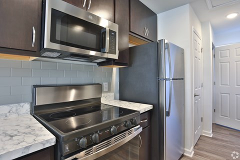 A kitchen with a stainless steel oven and microwave.