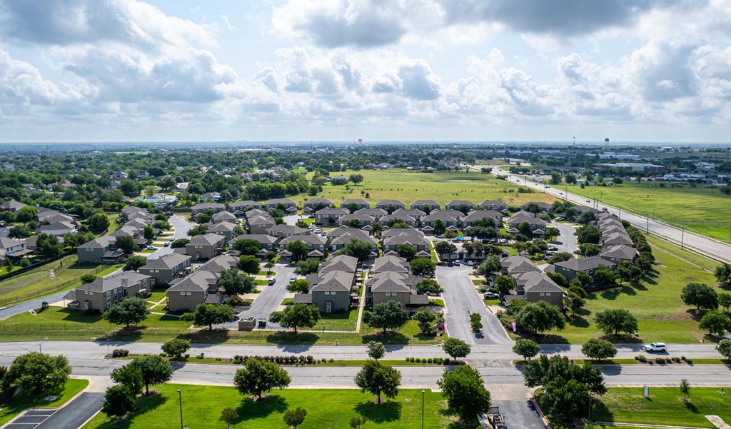A suburban neighborhood with rows of houses and streets.