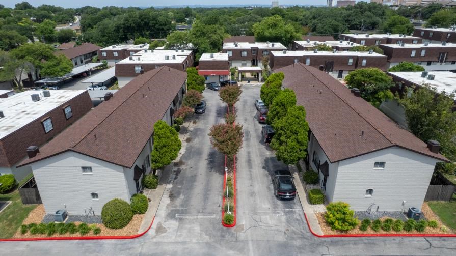 A street view of a residential area with houses on both sides.