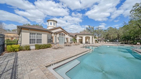 A large house with a pool in front.