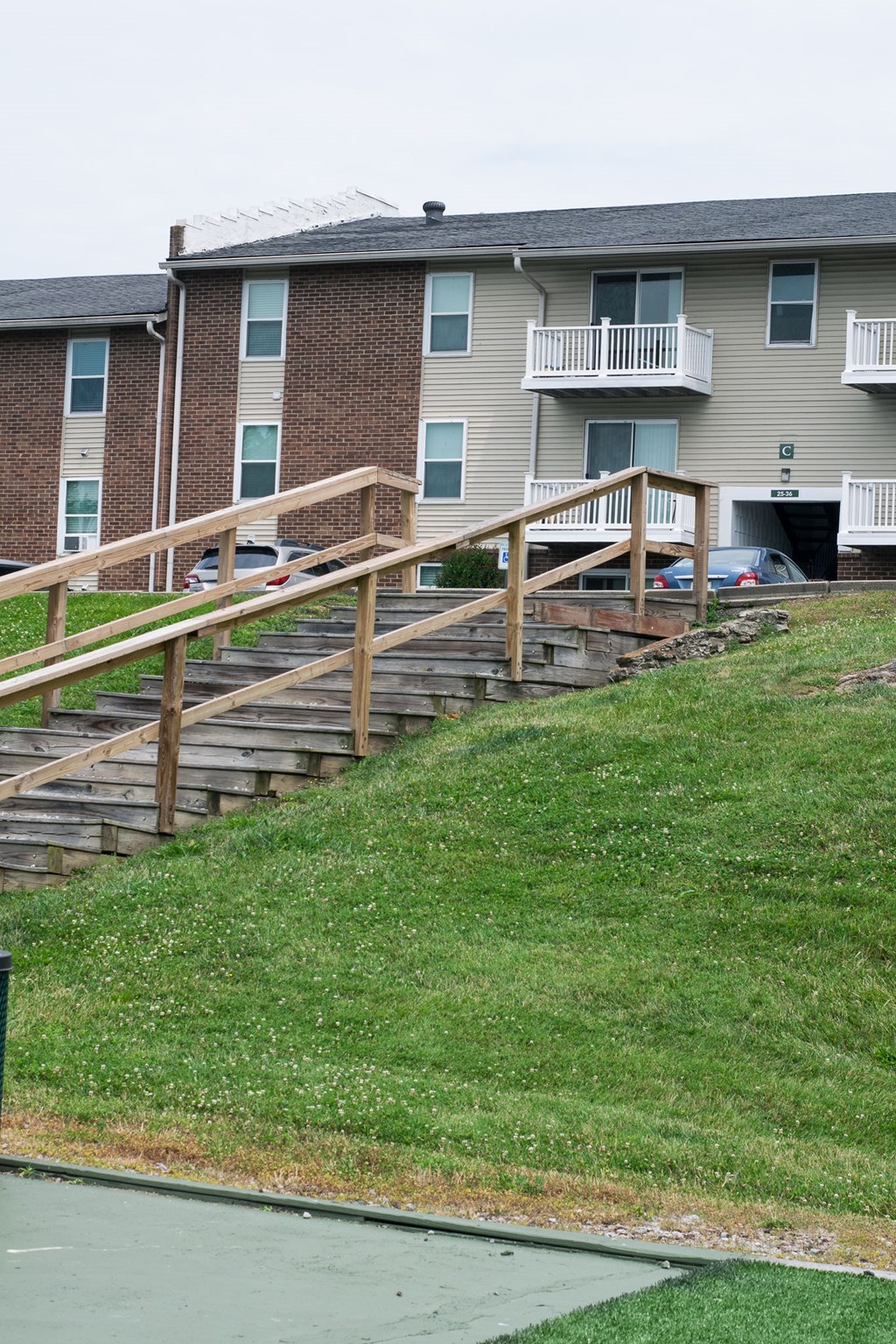 A building with a green lawn in front.