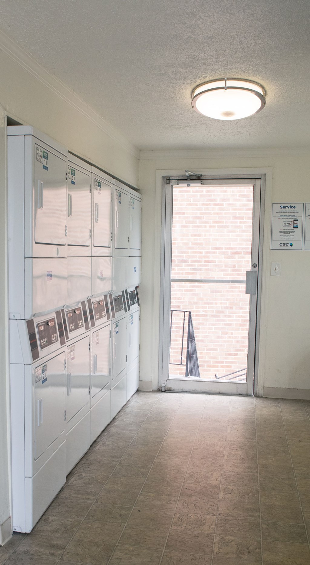 A white refrigerator with a door open and a sign on the wall.