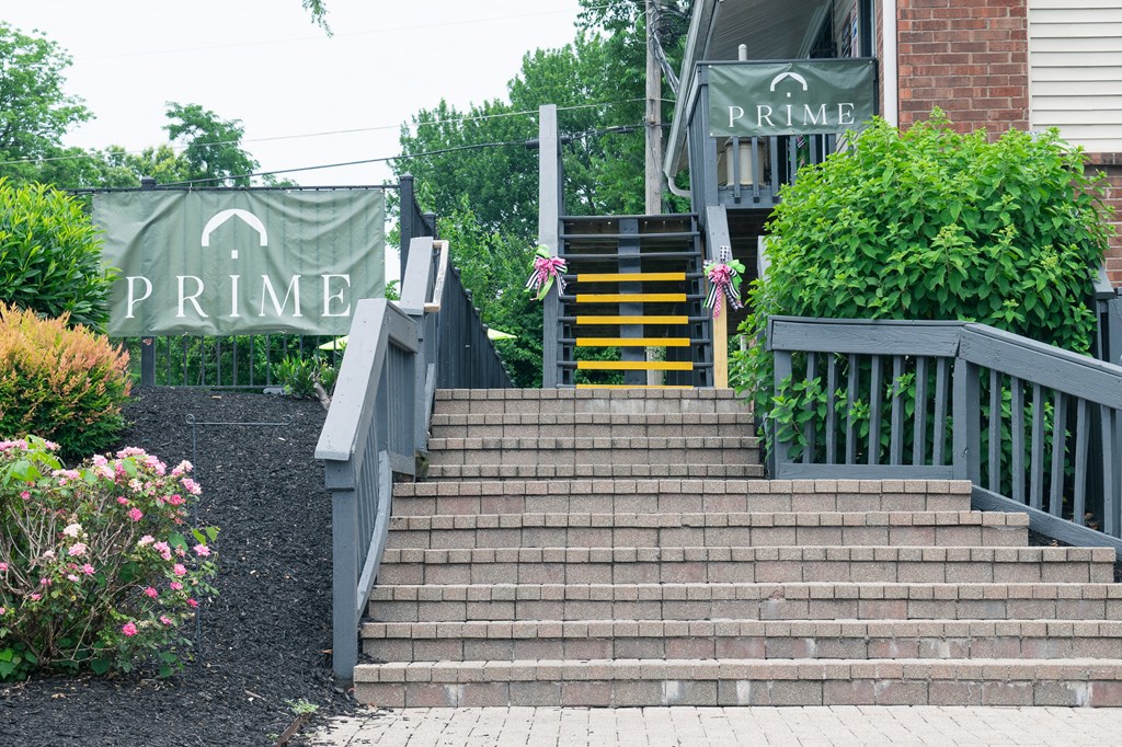 A set of stairs leading up to a building with a sign that says Prime.