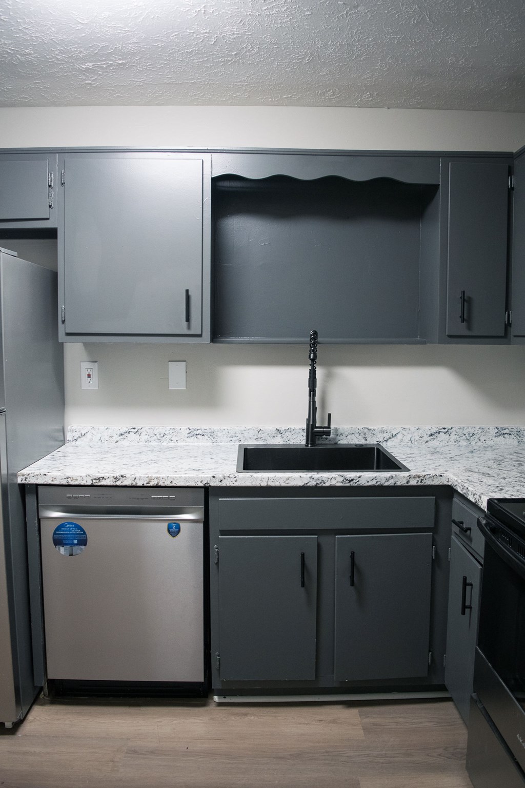 A kitchen with a sink and a dishwasher.