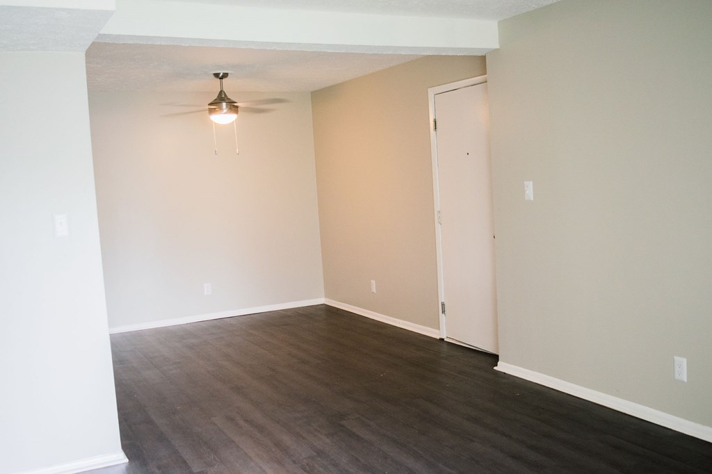 A room with a white door and a light hanging from the ceiling.