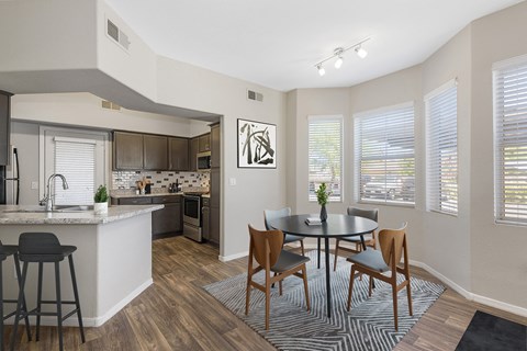 an open kitchen and dining room with a table and chairs