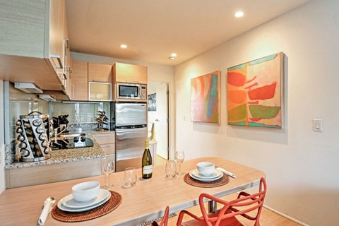 a kitchen and dining room with a table and chairs