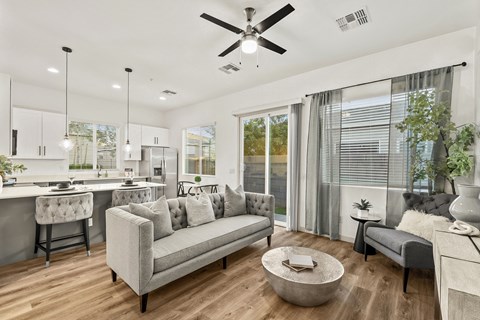 A modern living room with a grey sofa and a wooden coffee table.
