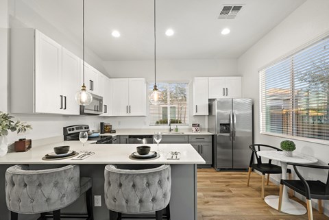 A modern kitchen with a dining table and chairs.
