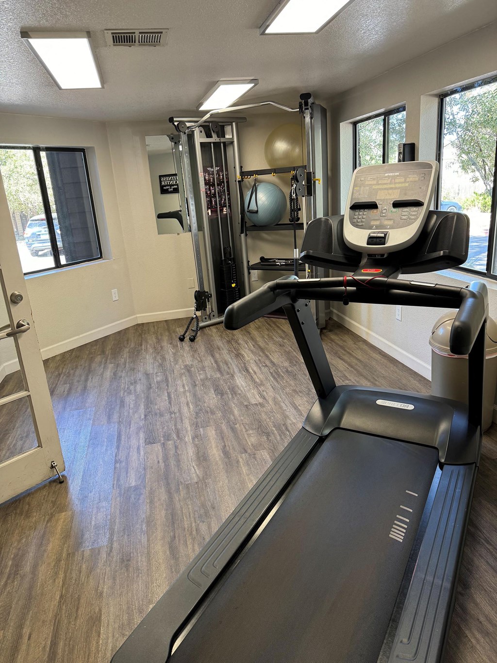 a gym with a treadmill and a chair in it