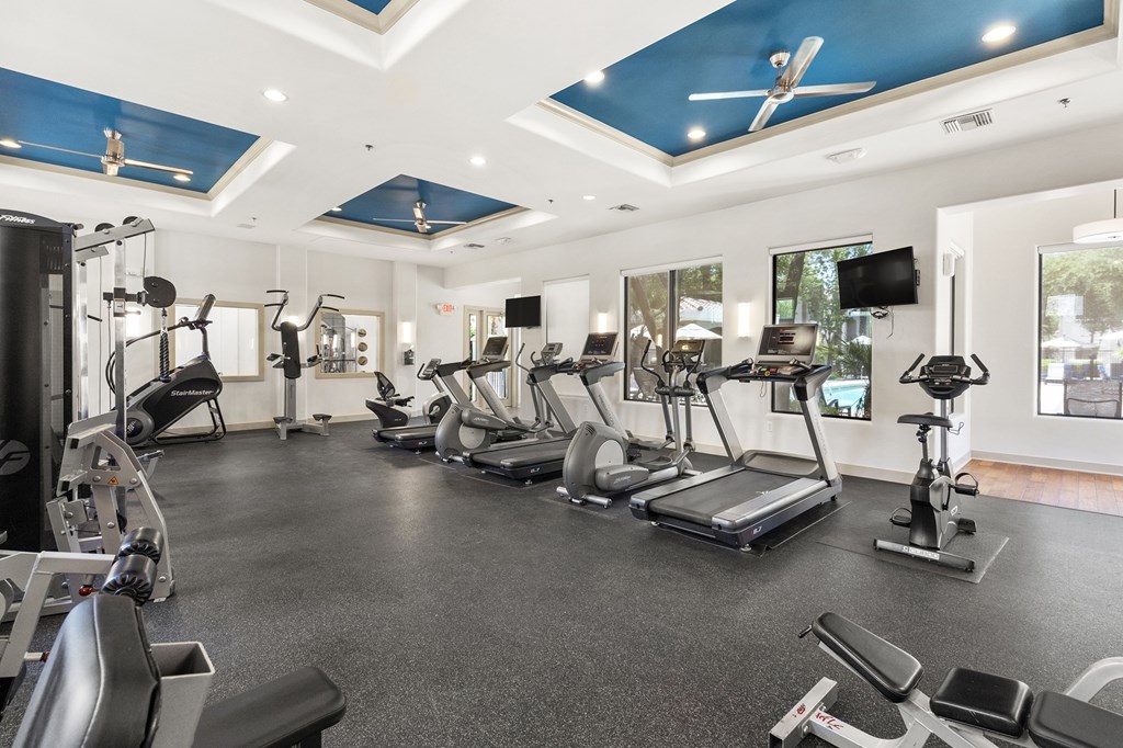 A spacious gym with a variety of exercise equipment.