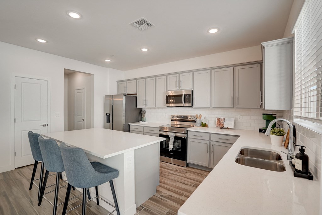 a kitchen with white cabinets and a white counter top