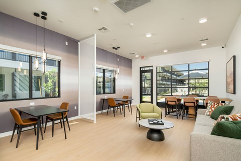 A modern dining room with a glass table and chairs.