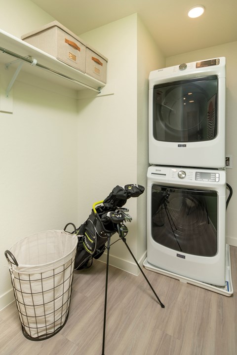 A white microwave oven is on top of a white dishwasher in a kitchen.