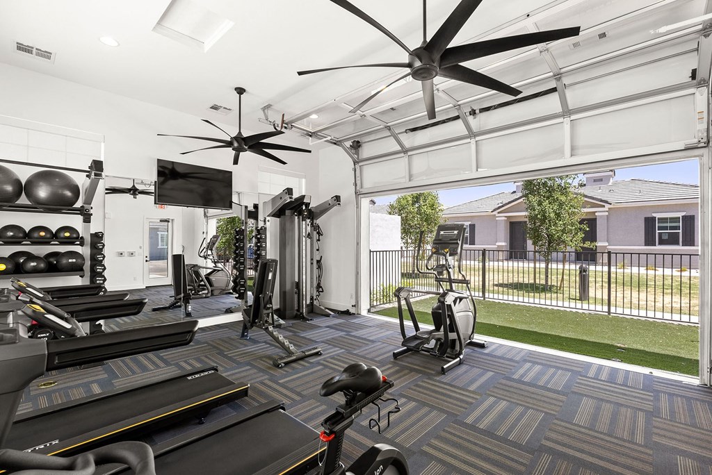 Gym with garage door at Zora Encanto Apartments in Phoenix Arizona