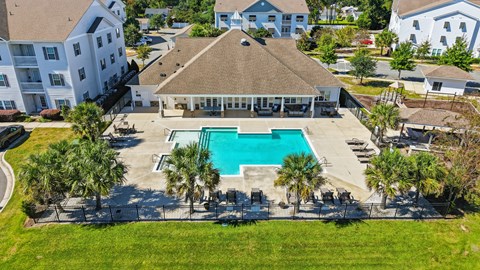 A large building with a pool in front of it.