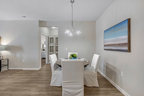 A dining room with a table set for four.