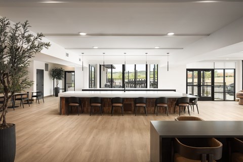 A modern dining room with a long table and chairs.