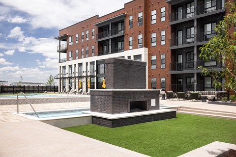 A modern brick building with a pool in front.