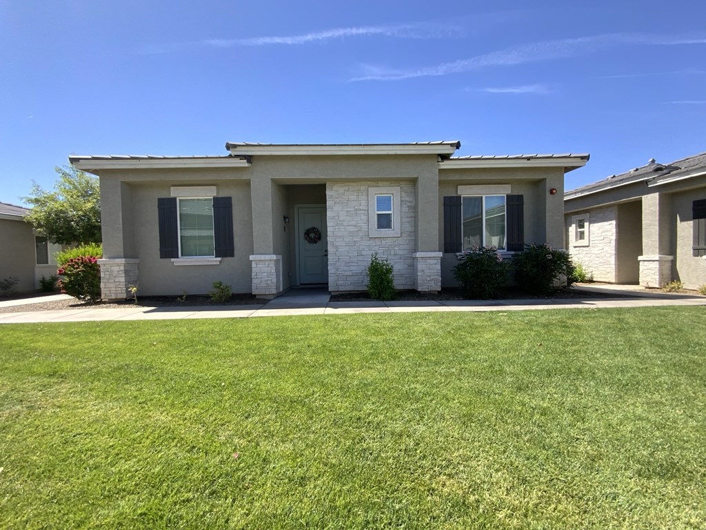 A house with a white door and black shutters.