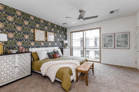A bedroom with two beds and a ceiling fan.