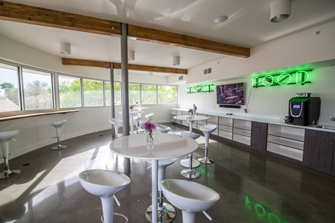 A modern dining area with a white table and chairs.