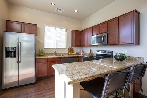 a kitchen with stainless steel appliances and a granite counter top