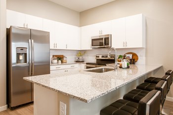Kitchen Breakfast Bar at The Carson Townhome Apartments - Photo Gallery 4