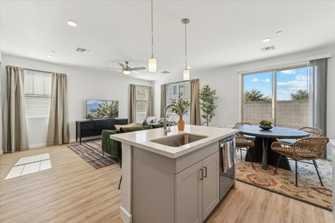 A modern kitchen with a dining table and chairs.