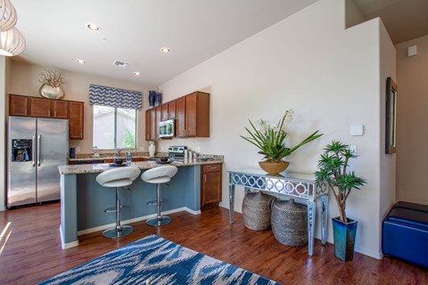 a kitchen with a breakfast bar and a refrigerator
